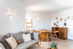 a living room with a couch and a table at Carvoeiro -Spacious 2 bedroom appartment with pool - Monte Dourado in Carvoeiro