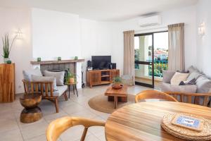 a living room with a couch and a table at Carvoeiro -Spacious 2 bedroom appartment with pool - Monte Dourado in Carvoeiro