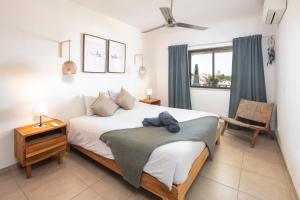 a bedroom with a bed and a chair and a window at Carvoeiro -Spacious 2 bedroom appartment with pool - Monte Dourado in Carvoeiro +15 photos
