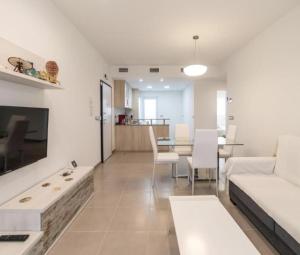 a living room with a white couch and a table at Sea Arenales del Sol in Arenales del Sol