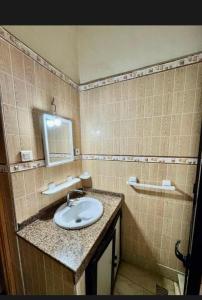 a bathroom with a sink and a mirror at Dar Lala Fatima Zahrae in Rabat
