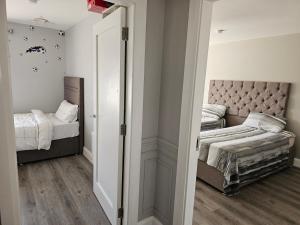 a bedroom with two twin beds and a mirror at Dublin Modern 4-5 bedroom house in Dublin