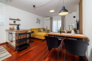 a kitchen and living room with a yellow couch at Apartment Iva in Šilo +27 photos