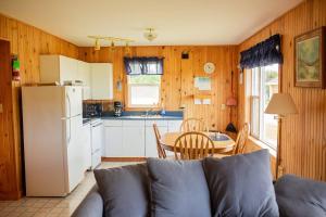 a kitchen with a couch and a table and a refrigerator at Greenwich View Cottages (Unit #3) in Saint Peters +16 photos