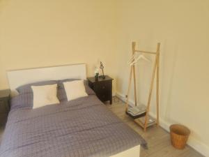 a bedroom with a bed and a dresser and a mirror at Arundel Road, RM30RX in Harold Wood