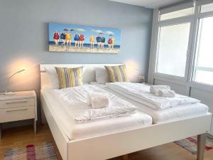 En eller flere senge i et værelse på Frische-Brise-FeWo-12-06