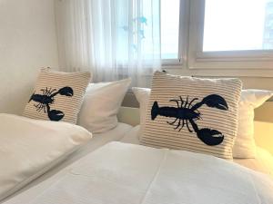 En eller flere senge i et værelse på Frische-Brise-FeWo-03-09