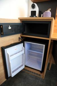 a small refrigerator with its door open in a kitchen at 7Rooms in Reutlingen +83 photos