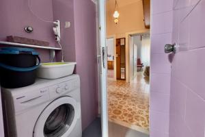 a pink laundry room with a washing machine in it at Da Susanne, Central Agropoli apartment in Agropoli