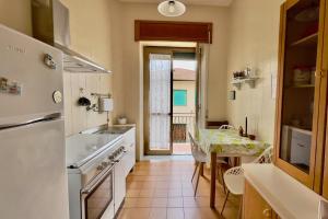 a kitchen with a table and a dining room at Da Susanne, Central Agropoli apartment in Agropoli