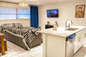 a kitchen and living room with a zebra print couch at Elvis' lovely home near Graceland in Memphis +13 photos