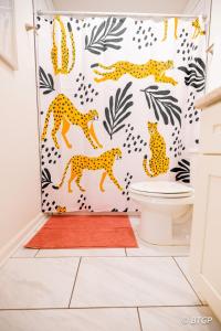 a bathroom with a cheetah shower curtain at Elvis' lovely home near Graceland in Memphis