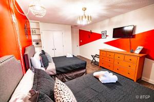 a living room with two beds and a tv at Elvis' lovely home near Graceland in Memphis