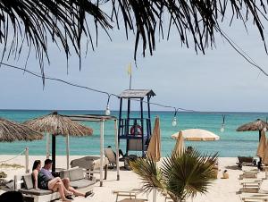 a group of people sitting in chairs on the beach at Boadream Ca' Madeira 2 Attico Linea Prestige in Sal Rei