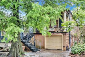 a house with a staircase leading up to a garage at Historic Home Near City Park Nola in New Orleans