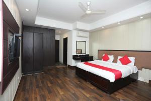 a bedroom with a large bed and a television at Super Hotel O The Avenue Residency in Gurgaon