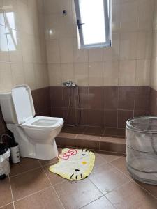 a bathroom with a toilet and a rug on the floor at Villa Valentina in Metogjashta +41 photos