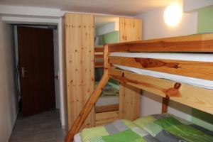 a bedroom with two bunk beds and a hallway at Ferienwohnung NeLe in Kappel-Grafenhausen