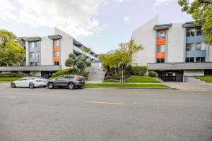 two cars parked in a parking lot in front of a building at Glendale 1BR w Pool Gym walkable location LAX-425 in Glendale
