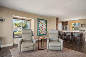 a living room with two chairs and a kitchen at Pembrook Paradise Monthly Rental Only in Cambria
