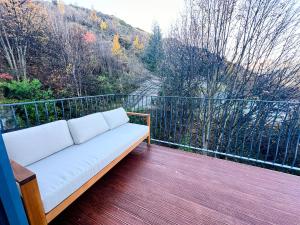 a white couch sitting on a deck with a view at Cosy Queenstown Home with Breathtaking Views in Queenstown +22 photos
