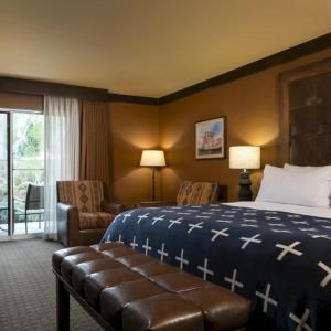 a hotel room with a bed and a chair at Wayfinder Bishop in Bishop