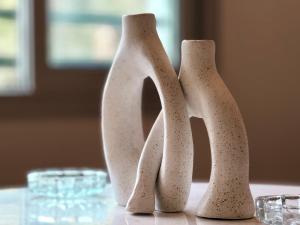 three white vases sitting on top of a table at Mirage residence resort in Cairo