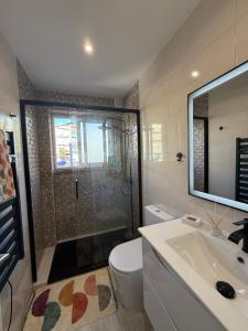 a bathroom with a shower and a toilet and a sink at Casa Solace in Almada
