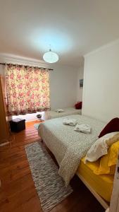 a bedroom with two beds and a window at Asian Everest House in Lisbon