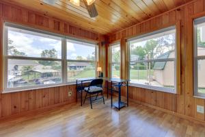a room with windows and a table and chairs at East Palatka Vacation Rental, Anglers Paradise in East Palatka