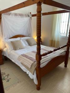 a bed with a wooden bed frame in a bedroom at Luxury Pool Villa in Arenas - Andalusia in Los Valverde