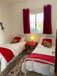 two beds with teddy bears on them in a bedroom at Luxury Pool Villa in Arenas - Andalusia in Los Valverde +14 photos