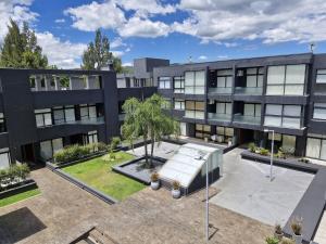 Un edificio de apartamentos con un patio con un sofá. en Departamento VCP Costanera, en Villa Carlos Paz