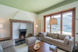a living room with a couch and a fireplace at Villa Chiara Lake Como with private garden in Moltrasio