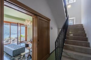 a room with a staircase with a bed and a glass door at Villa Chiara Lake Como with private garden in Moltrasio +46 photos