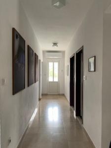 a hallway with white walls and pictures on the walls at Apartments with parking space Korcula - 180 in Korčula