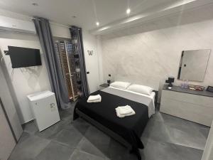 a bedroom with a bed with two towels on it at La Farfalla in Milazzo