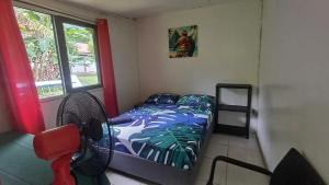 A bed or beds in a room at Nuku Hiva Pitake Lodge