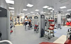 a gym with lots of equipment and people in it at City Premiere Hotel Apartments - Dubai in Dubai