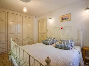 a bedroom with a bed with two pillows on it at Apartamenty i pokoje Mikołajki in Mikołajki