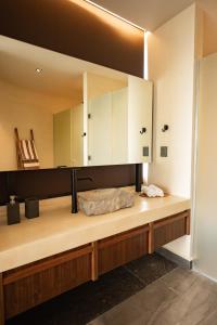 a bathroom with a sink and a mirror at Jungle Sunset Penthouse in Tulum with Private Pool, 5 Min from Beach in Tulum