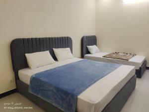 two beds sitting next to each other in a room at Islamabad Dream Palms Guest House Hotel in Islamabad +40 photos