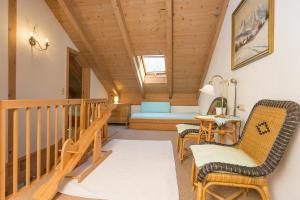 a living room with a staircase and a couch at Ferienhaus Alp Chalet in Kochel