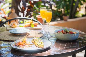 a table with plates of food and a glass of orange juice at Villas VR Beachwalk Avellanas in Playa Avellana +121 photos