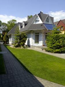a white house with a black roof and a lawn at Iso Apartman Siófok in Siófok +18 photos