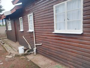 a wooden house with a toilet on the side of it at house no 672 simile sabie location in Vosburg