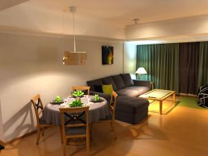 a living room with a couch and a table at Large family room near Metro Taipei station for comfort and convenience, where 5 can relax and create unforgettable moments in Taipei