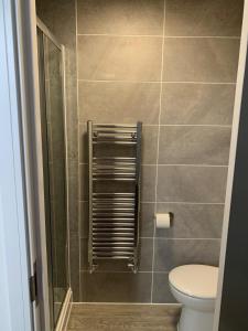 a bathroom with a toilet and a shower stall at Kings Cross by Pureserviced in Plymouth +28 photos