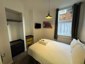 a bedroom with a white bed and a window at Kings Cross by Pureserviced in Plymouth