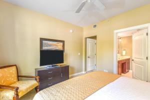 a bedroom with a bed and a tv and a chair at 4106-1 Cozy Ground Floor 1 BR with fenced patio in Saint Augustine +35 photos